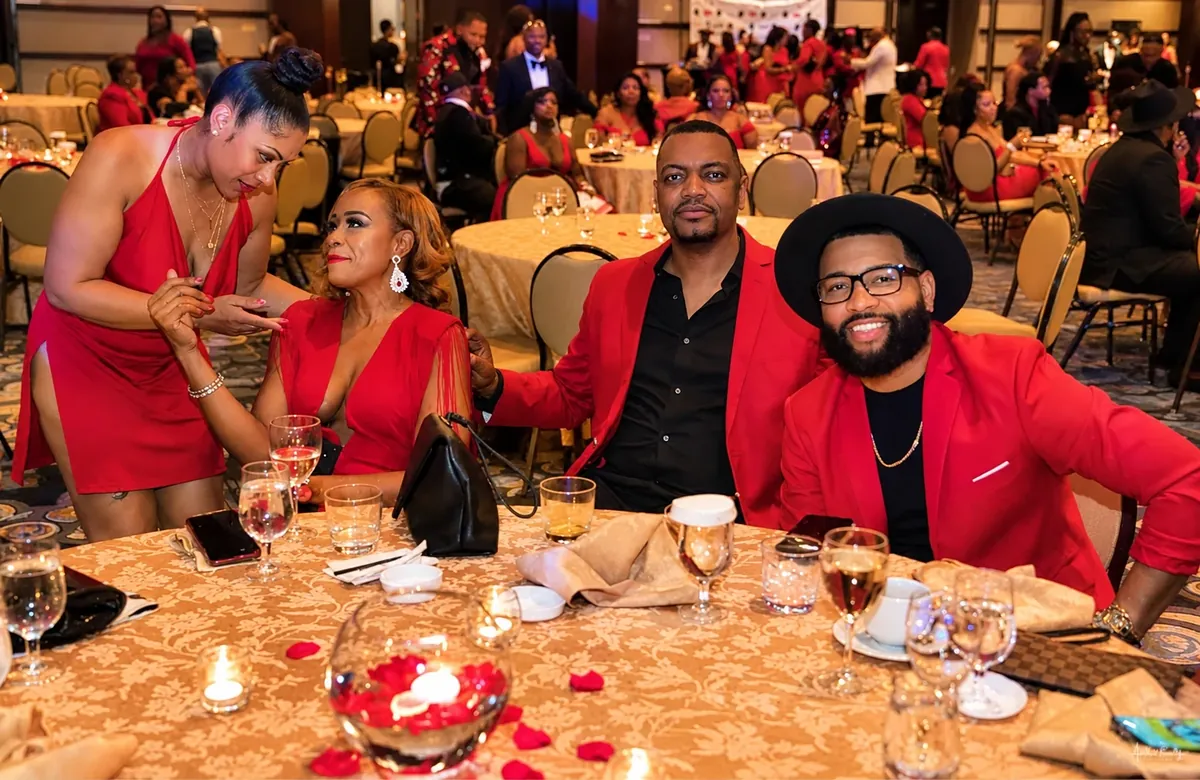 Guests in red attire enjoying a celebration around a decorated banquet table